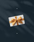 Gift card with a gold bow on a dark background